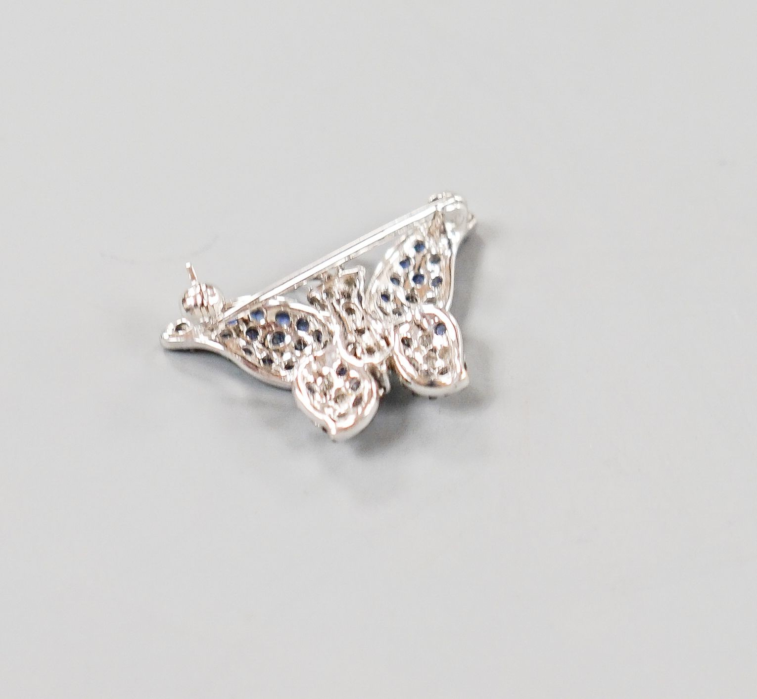 A modern 18ctwhite gold, pave set sapphire and diamond set butterfly brooch, 25mm, gross weight 4.5 grams.